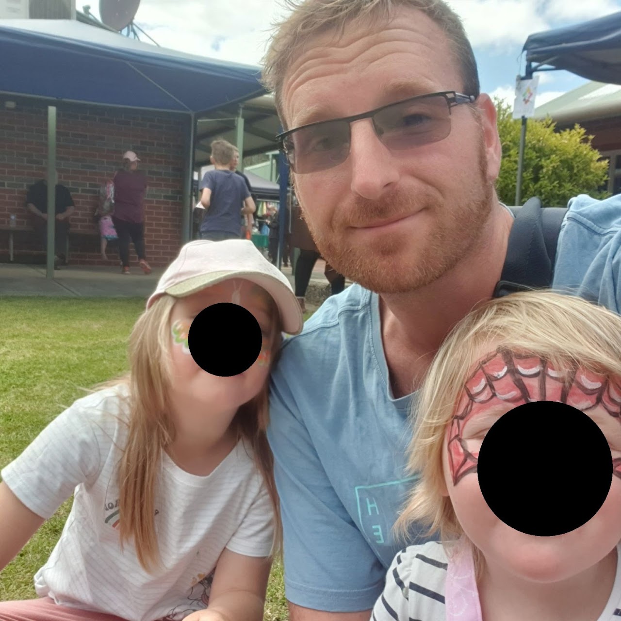 Andrew with his two daughters at a local community fair